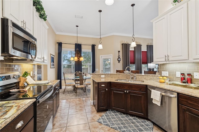 kitchen featuring pendant lighting, dark brown cabinets, sink, and stainless steel appliances