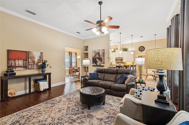 living room featuring dark hardwood / wood-style floors, ceiling fan, and ornamental molding