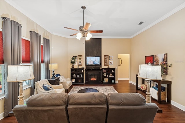 living room featuring a fireplace, crown molding, dark hardwood / wood-style flooring, and ceiling fan