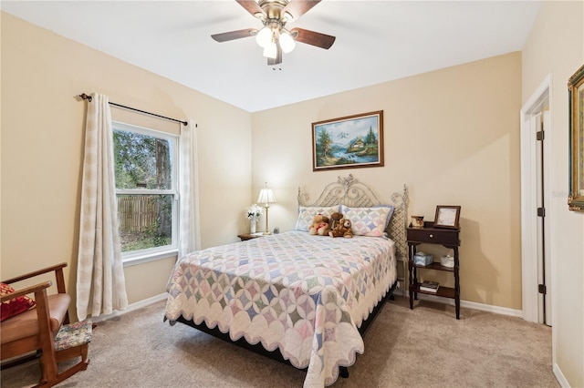 bedroom featuring ceiling fan and light colored carpet