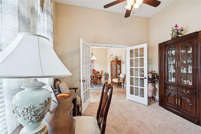 carpeted dining space with french doors and ceiling fan