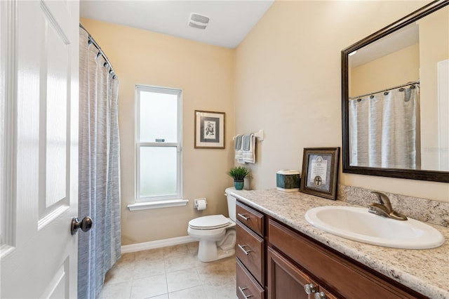 bathroom with tile patterned flooring, vanity, and toilet