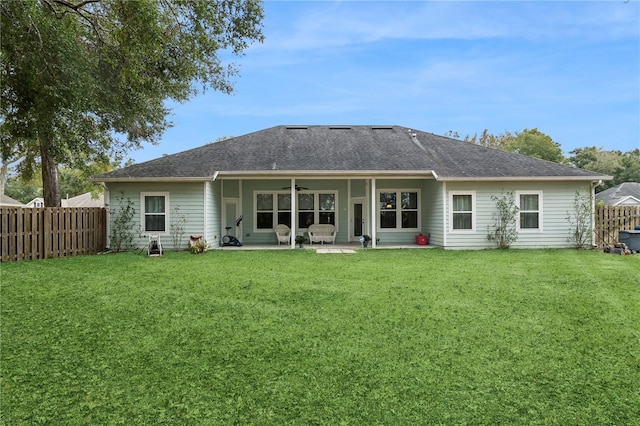 back of property featuring a yard, ceiling fan, and a patio area