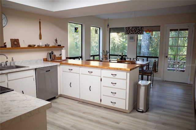 kitchen with white cabinets, light wood-type flooring, kitchen peninsula, and stainless steel dishwasher