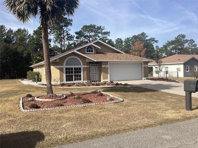 ranch-style home with a garage and a front yard