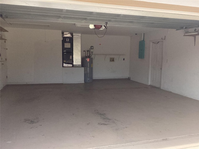 garage featuring electric panel, water heater, heating unit, and a garage door opener