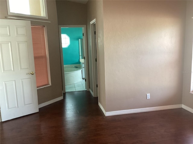 corridor with dark hardwood / wood-style floors