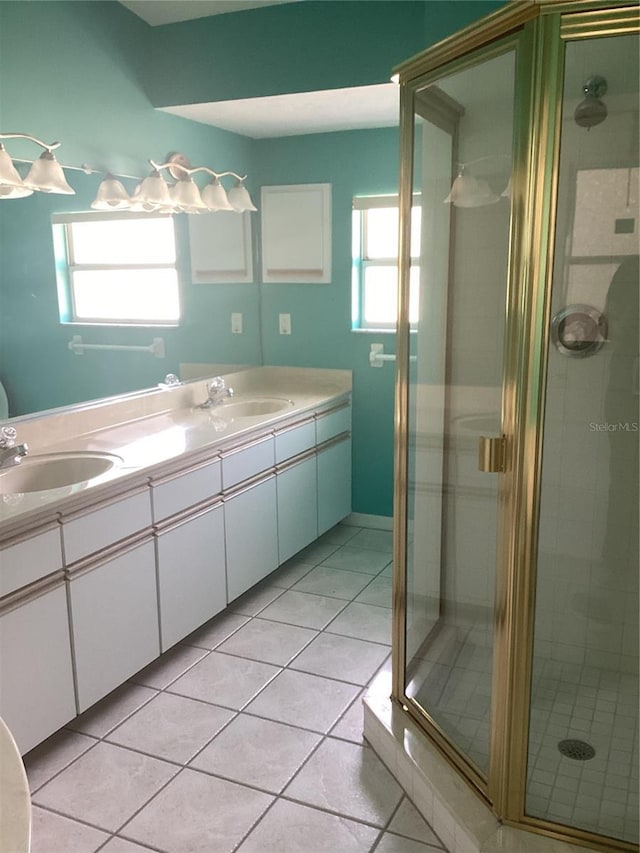 bathroom featuring tile patterned floors, a wealth of natural light, and a shower with shower door