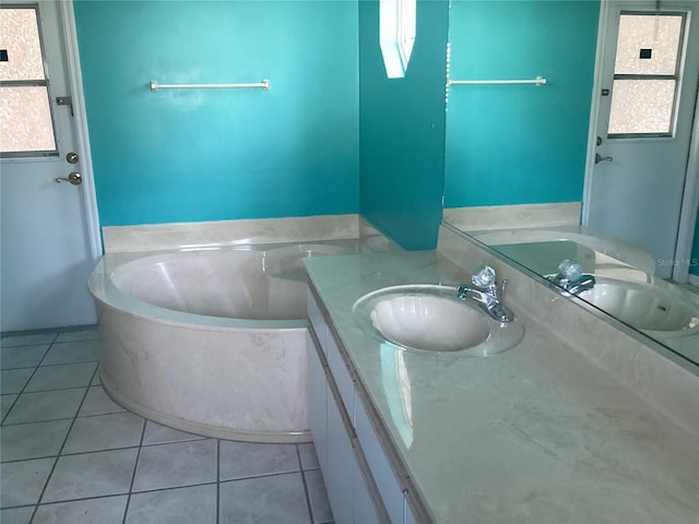 bathroom featuring vanity, tile patterned flooring, and a bathtub