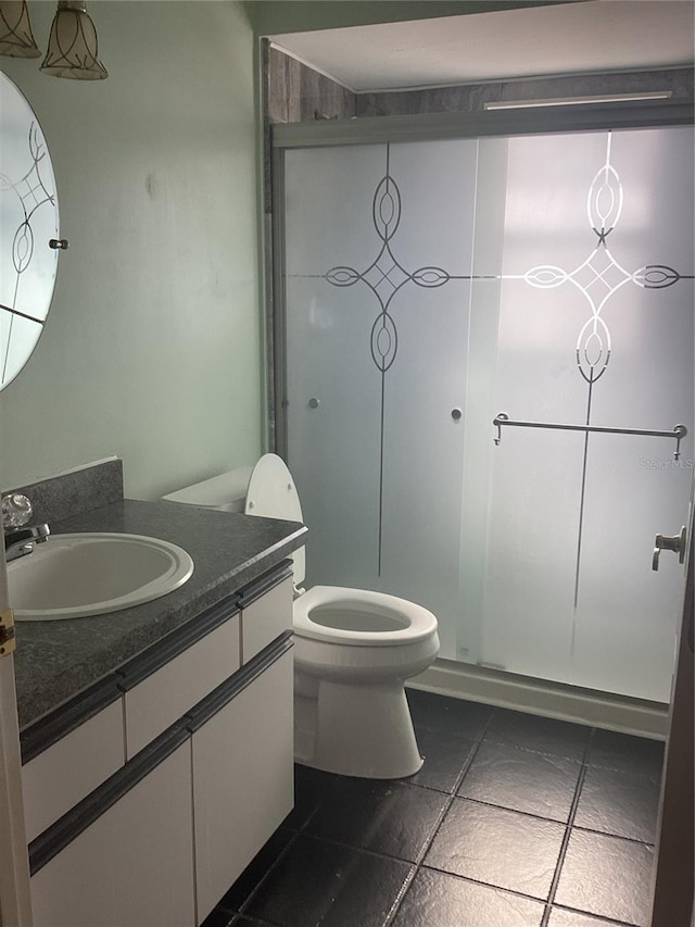 bathroom with tile patterned floors, vanity, and toilet