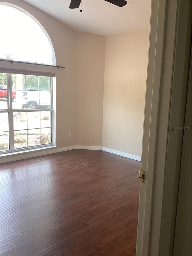 empty room featuring dark hardwood / wood-style floors and ceiling fan