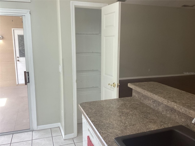 interior space featuring tile patterned flooring and sink