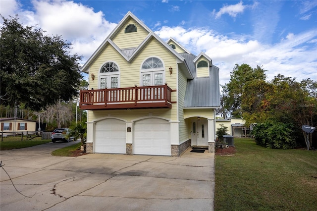 view of front of home with a front yard, a balcony, a garage, and central AC unit