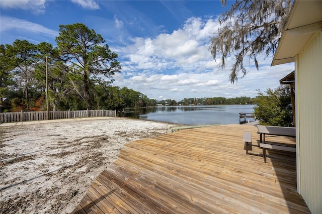 wooden terrace featuring a water view