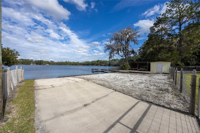 view of patio / terrace featuring a water view and a shed