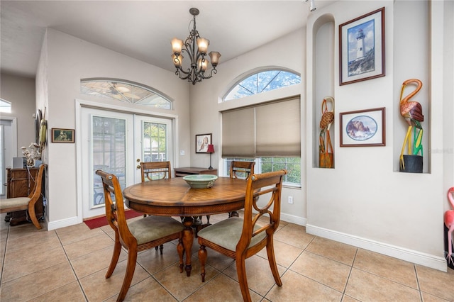 tiled dining room featuring french doors and an inviting chandelier