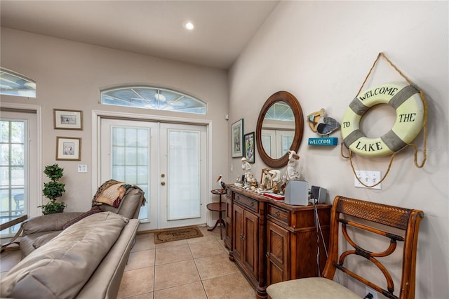 tiled foyer entrance featuring vaulted ceiling and french doors