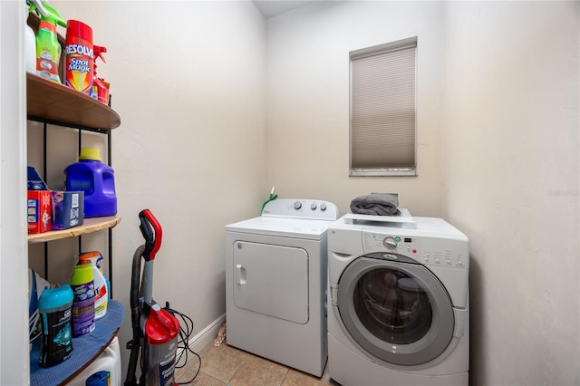 washroom with washing machine and clothes dryer and light tile patterned flooring