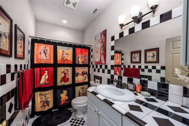 bathroom featuring tile patterned flooring, vanity, toilet, and backsplash