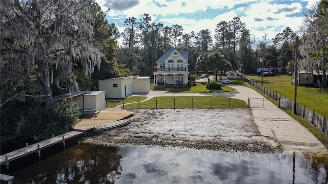 view of yard with a storage unit and a water view