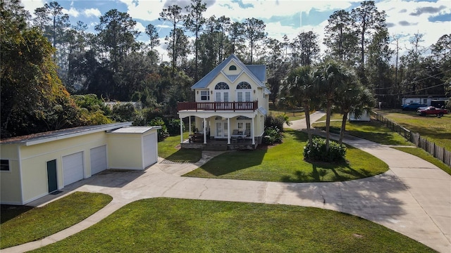 exterior space with covered porch, a balcony, a garage, and a front lawn