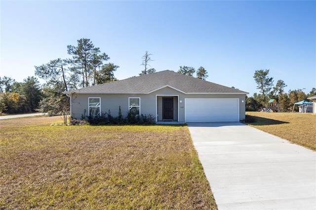 single story home with a garage and a front lawn