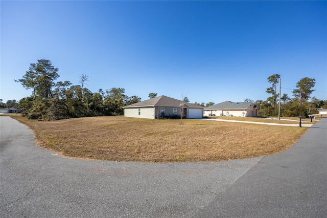 single story home with a front yard and a garage