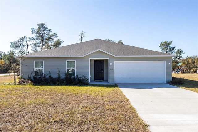 ranch-style home with a front yard and a garage