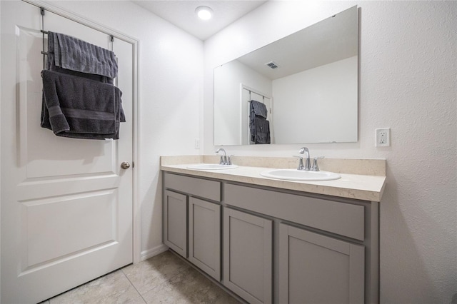 bathroom with tile patterned floors and vanity