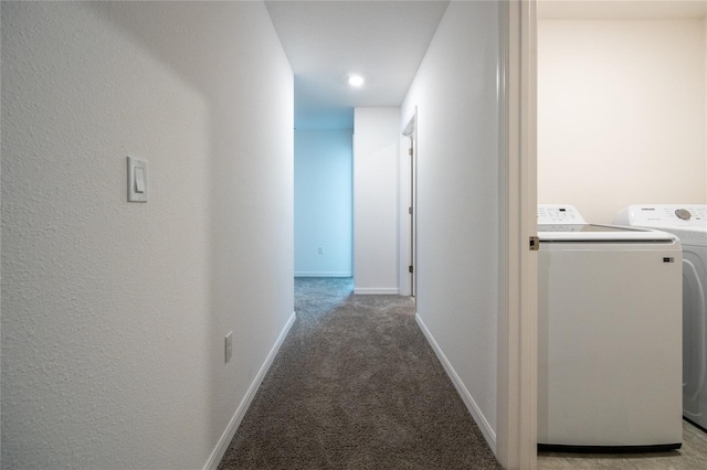 corridor featuring light carpet and washer and dryer