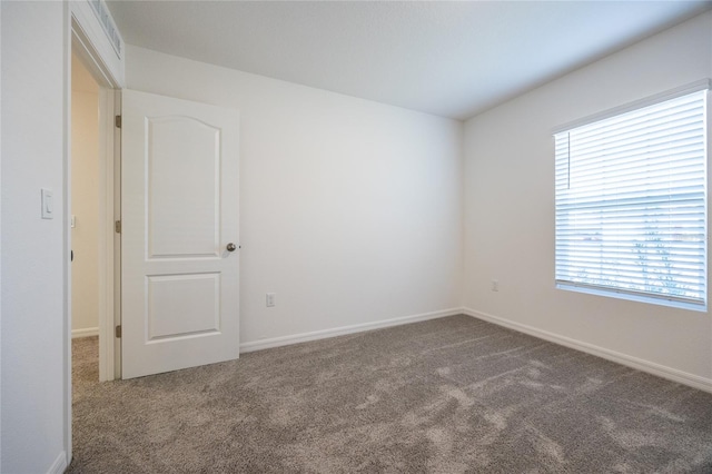 unfurnished room featuring carpet