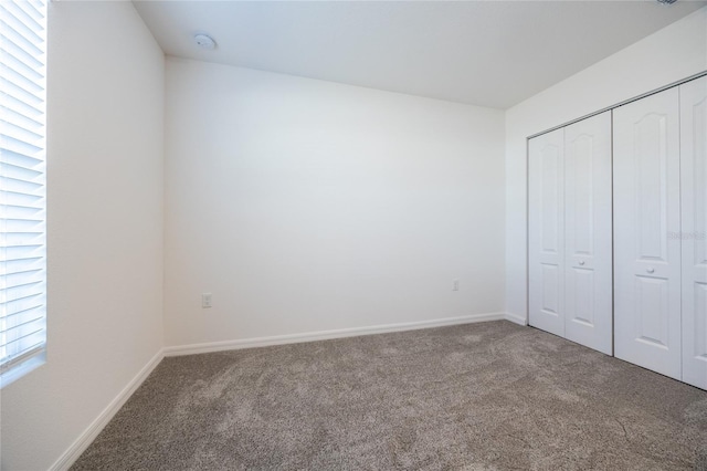 unfurnished bedroom with carpet floors and a closet