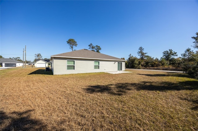 rear view of property featuring a yard