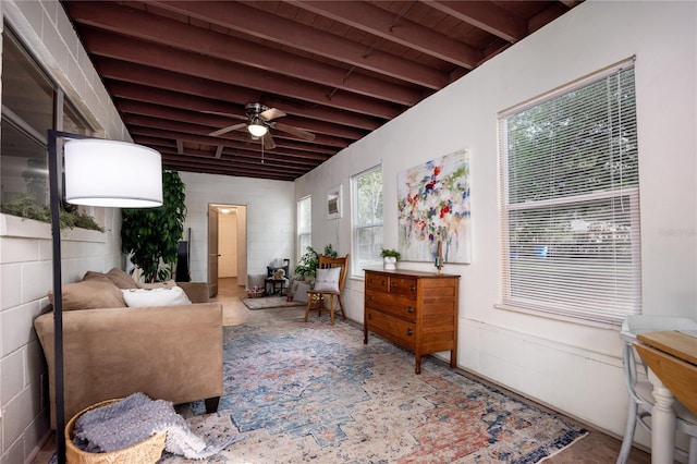 sitting room with beamed ceiling and ceiling fan