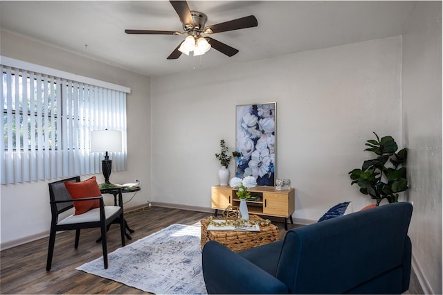 living room featuring ceiling fan and dark wood-type flooring