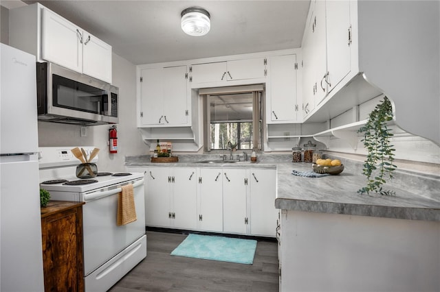 kitchen featuring dark hardwood / wood-style flooring, white appliances, white cabinetry, and sink