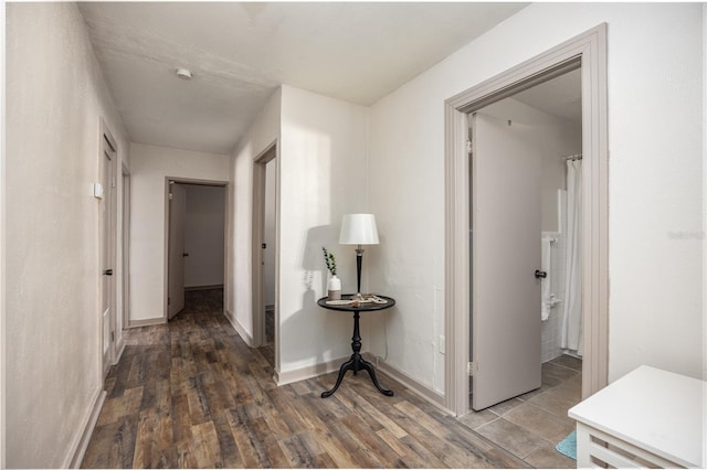 corridor featuring dark hardwood / wood-style flooring