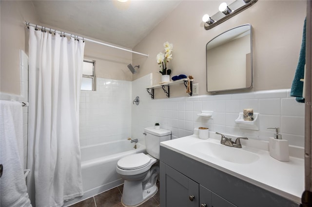 full bathroom featuring vanity, tile patterned floors, shower / bath combination with curtain, toilet, and tile walls