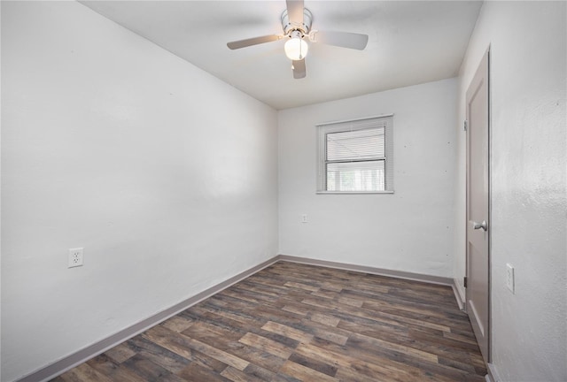 empty room with ceiling fan and dark wood-type flooring