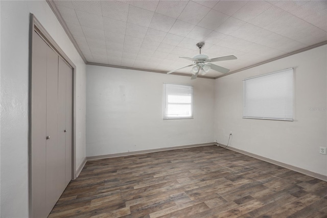 unfurnished bedroom with ceiling fan, dark hardwood / wood-style flooring, and ornamental molding