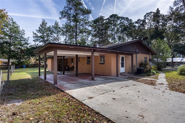 back of property with a yard, a patio, and central AC unit