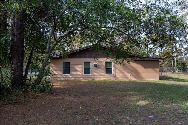 rear view of house featuring a lawn