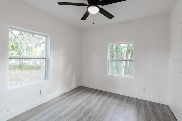 empty room with wood finished floors and baseboards