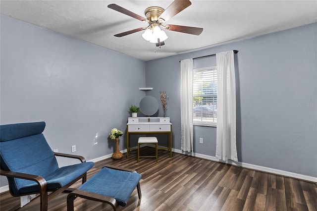 sitting room featuring ceiling fan and dark wood-type flooring