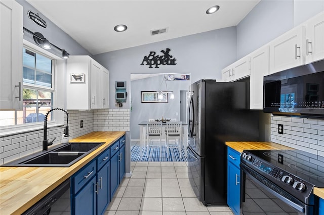 kitchen featuring blue cabinetry, white cabinets, black appliances, and vaulted ceiling