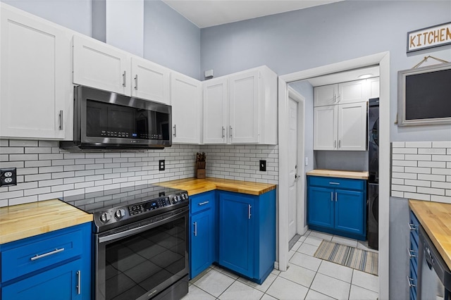 kitchen with white cabinetry, wooden counters, light tile patterned floors, and stainless steel appliances