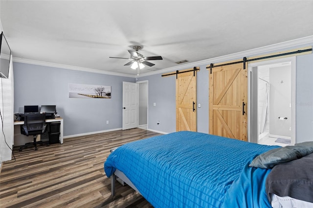 bedroom featuring ceiling fan, a barn door, dark hardwood / wood-style floors, ornamental molding, and connected bathroom