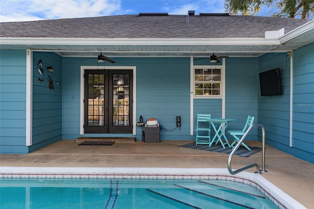 view of pool with french doors, ceiling fan, and a patio area