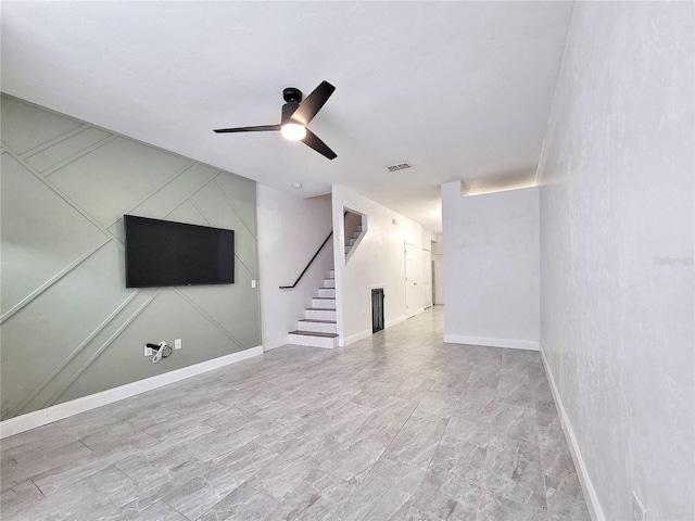 unfurnished living room with ceiling fan