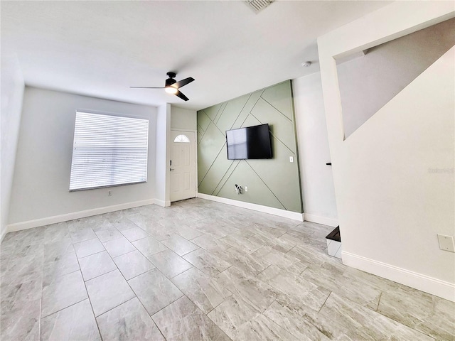 unfurnished living room featuring ceiling fan